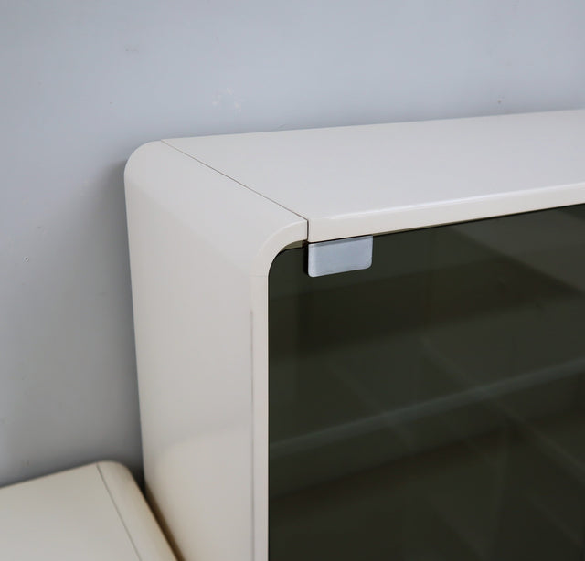1960s Italian Space Age white lacquered modular bookcase system with smoked glass doors and open shelving modules in a clean minimalist set.