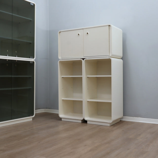 1960s Italian Space Age white lacquered modular bookcase system with smoked glass doors and open shelving modules in a clean minimalist set.
