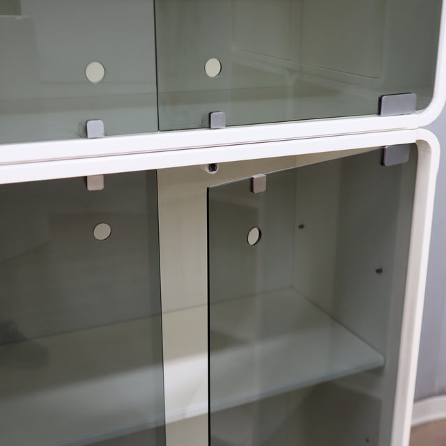 1960s Italian Space Age white lacquered modular bookcase system with smoked glass doors and open shelving modules in a clean minimalist set.