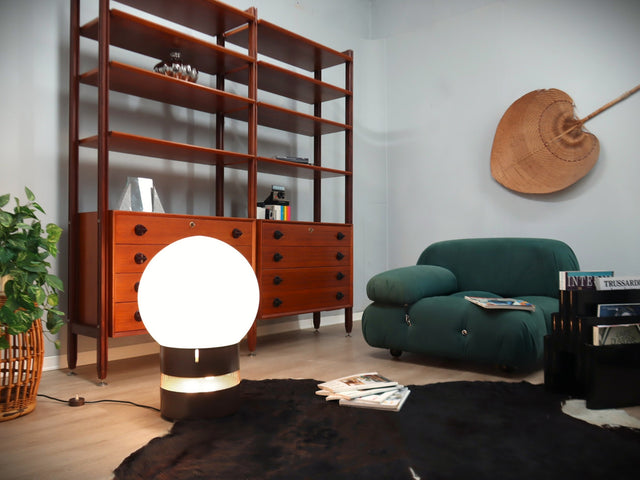 Gae Aulenti "Mezzo Oracolo" lamp for Artemide. Its commanding opaline glass globe acts as a luminous dome, diffusing light with a warm, ethereal glow. Below, the cylindrical metal base