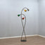 1950s Italian Biancardi e Jordan floor lamp with curved brass stem, green marble base, and multi-colored aluminum flower shades.