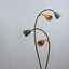 1950s Italian Biancardi e Jordan floor lamp with curved brass stem, green marble base, and multi-colored aluminum flower shades.