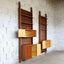 Asymmetric 1950s Italian teak wall unit with slatted back and plywood shelves. Teak Regal, estantería teca, bibliothèque teck, libreria dogat