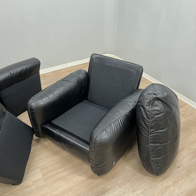Pair of 1970s Italian Busnelli Piumotto black leather armchairs with original stamped ABS bases. Coppia poltrone Piumotto Busnelli in pelle nera.