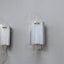 set of three 1970s Italian wall sconces masterfully combines geometric lines and layered transparency, chrome-plated steel frame, central white opaline plexiglass diffuser, enhanced by surrounding lamellar acrylic blades