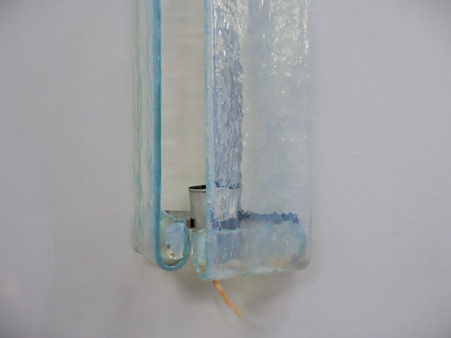 This refined set of three wall sconces, designed by Carlo Nason for AV Mazzega in the 1970s Each piece is crafted from Murano glass, transparent with delicate aquamarine hues