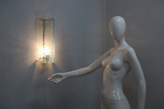 This refined set of three wall sconces, designed by Carlo Nason for AV Mazzega in the 1970s Each piece is crafted from Murano glass, transparent with delicate aquamarine hues