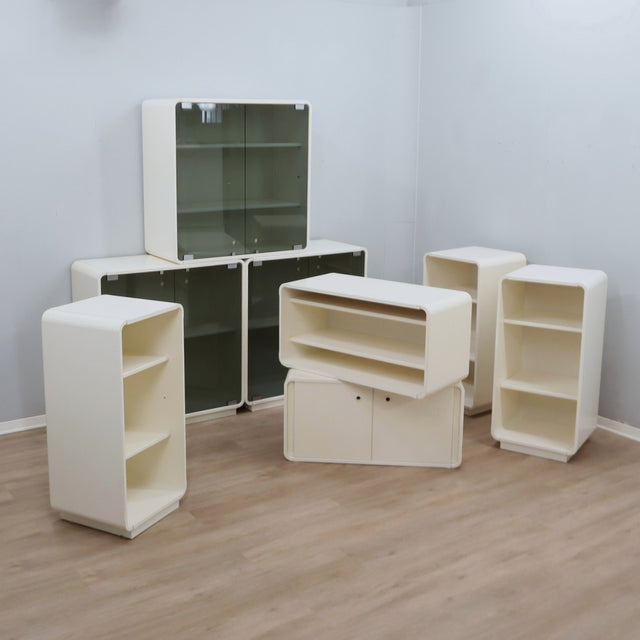 1960s Italian Space Age white lacquered modular bookcase system with smoked glass doors and open shelving modules in a clean minimalist set.   
