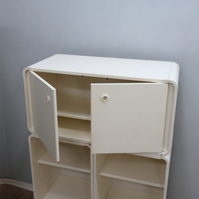 1960s Italian Space Age white lacquered modular bookcase system with smoked glass doors and open shelving modules in a clean minimalist set.   