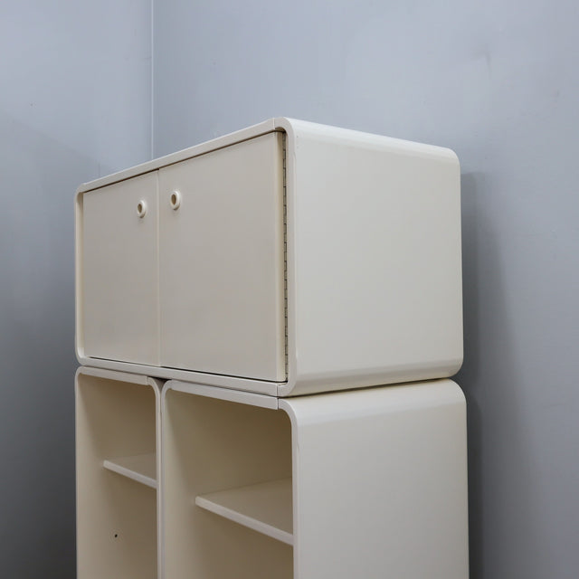 1960s Italian Space Age white lacquered modular bookcase system with smoked glass doors and open shelving modules in a clean minimalist set.   
